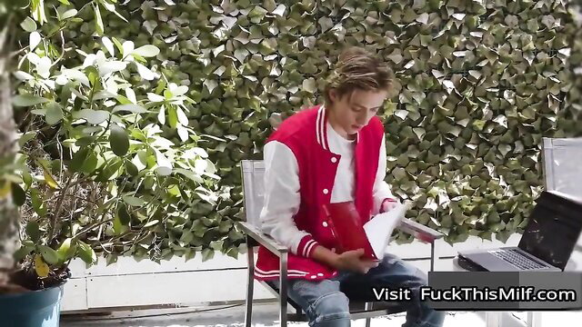 Blonde stepmom in varsity jacket reads with stepson, huge tits tease