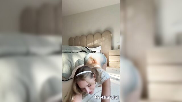 Caroline Zalog topless in bed, blonde head turned with hand on hair