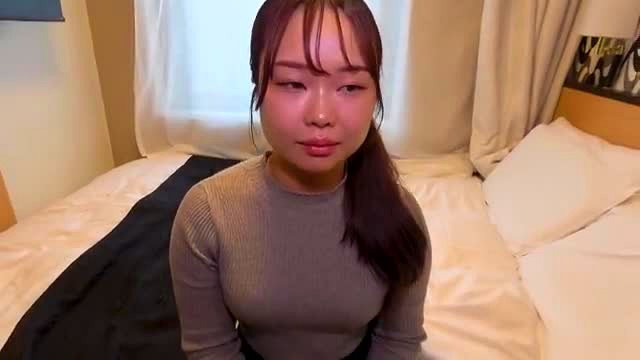 Cute chubby Japanese girl with nice tits in gray sweater on bed