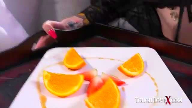 Rocky Emerson tattoos hand over orange slices plate in sexy tease