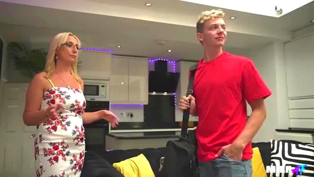 Blonde MILF in floral dress flirts with fit guy in red shirt at Airbnb