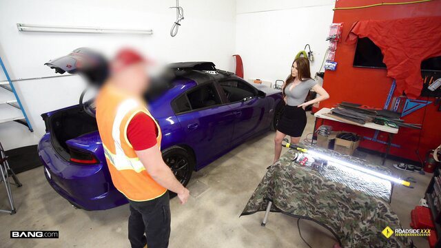 Brianna Rose in short skirt with mechanic by purple car in garage