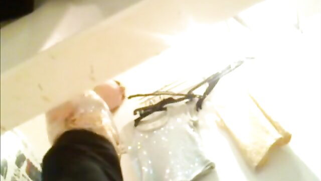 Teen blonde foot in clear heel with scissors on table, Jackpot Series