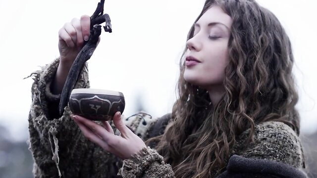 Elena Koshka as Elenka in mystical quest, holding bowl and snake