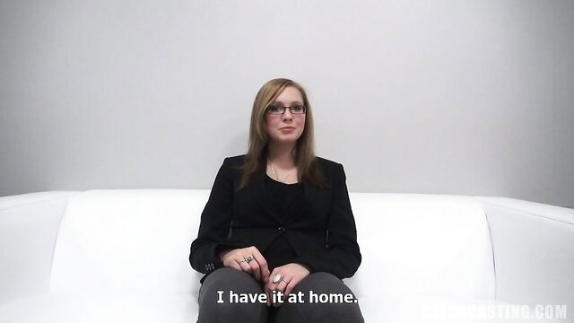Sweet amateur with glasses in tight black suit at sex casting couch