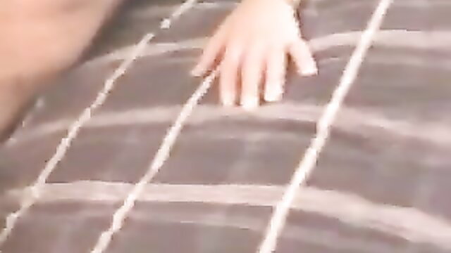 Cuckold wife hand stroking cock on bed closeup