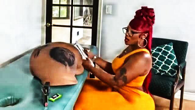 Cherokee D'Ass tattooing huge black ass in tight orange dress