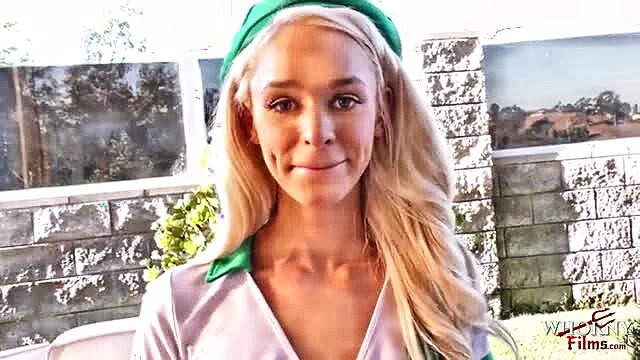 Emma Hix in green headband and shiny top, smiling outdoor tease