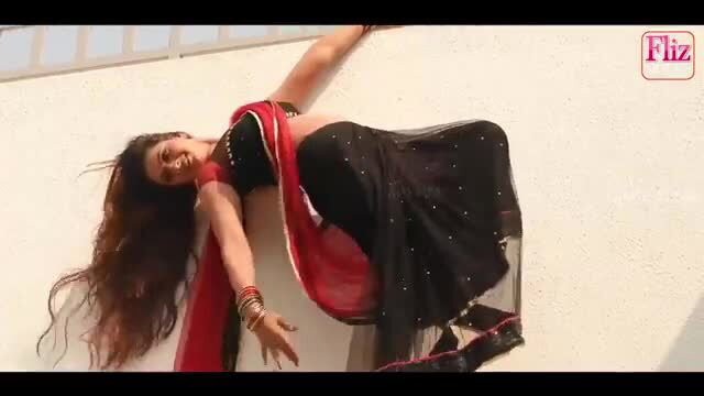 Sarla Bhabhi in sexy black saree, seductive pose on wall