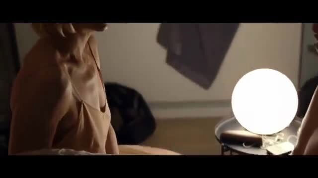 Seductive cougar MILF in tank top sits by lamp, teases young stud