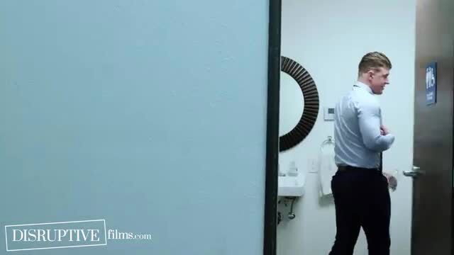 Handsome white guy in shirt and pants entering bathroom door
