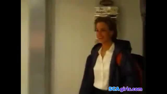 Brunette in white blouse and black hoodie smiles in gym threesome preview