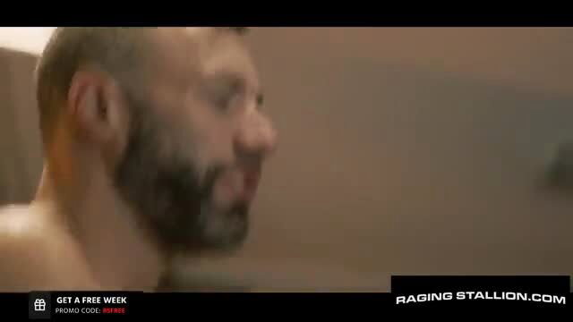 Muscular bearded man profile view in steamy Raging Stallion gay porn scene