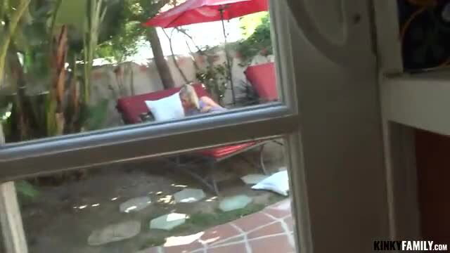 Dakota Bleu lounging nude outdoors in red chair