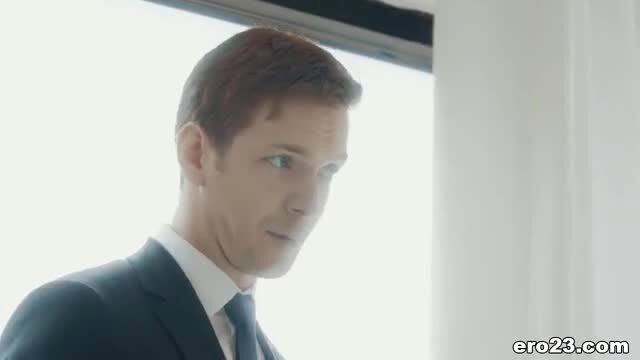 Handsome suited man in office window light, mature stud profile