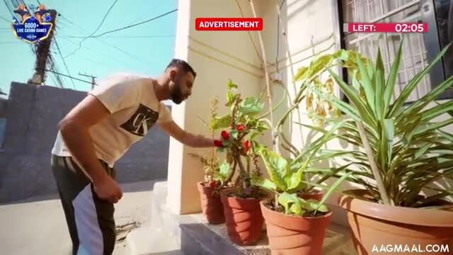 Jamuniya 18yo brunette teen in casual tee pants tending plants outdoors