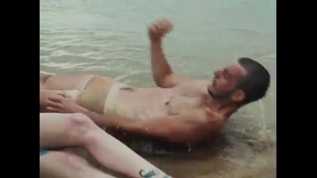 Clara de Lluvia hot wet outdoor lounging nude male in speedo