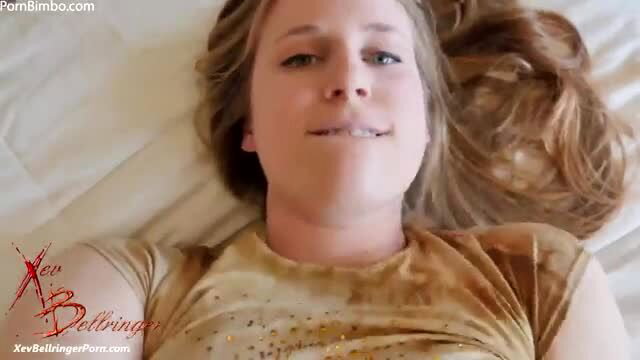 Xev Bellringer smiling in wet gold top, sexy bet tease