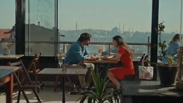 Neslihan Atagül in red dress on romantic outdoor date cafe scene