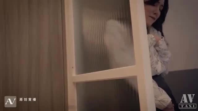 Chinese beauty in blouse peeking through frosted glass door, teasing pose