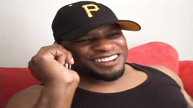 Smiling black man in Pirates cap on phone, huge dick thumbnail