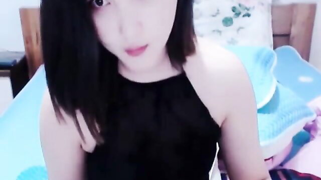 Shy Asian cam girl in black tube top closeup