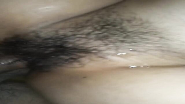 Closeup of wet hairy pussy with arousal fluids dripping