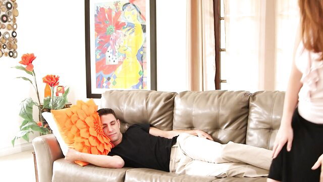 Alysson Moore stands over sleeping guy on couch in Big Titty Mom Blows Dick