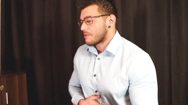 Muscular man in baby blue button-up shirt, handsome bearded model closeup