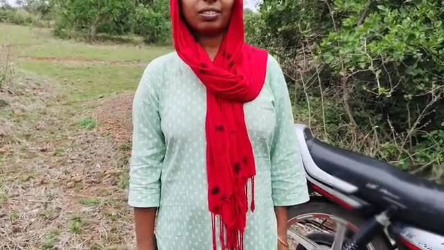 Young Indian Desi College Girl in hijab and salwar by motorcycle in jungle