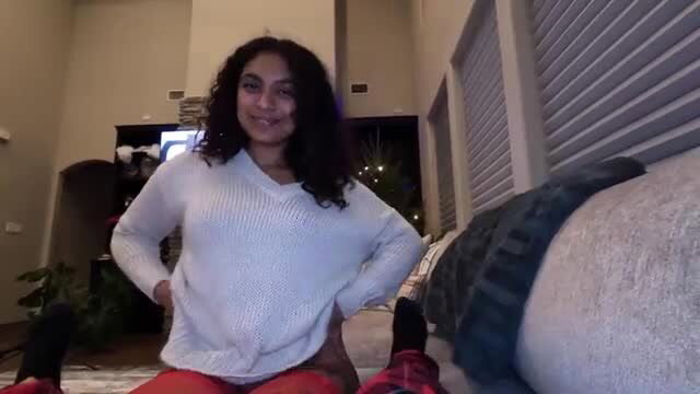 Curvy brunette amateur posing on couch in sweater and red pants for XXXmas creampie