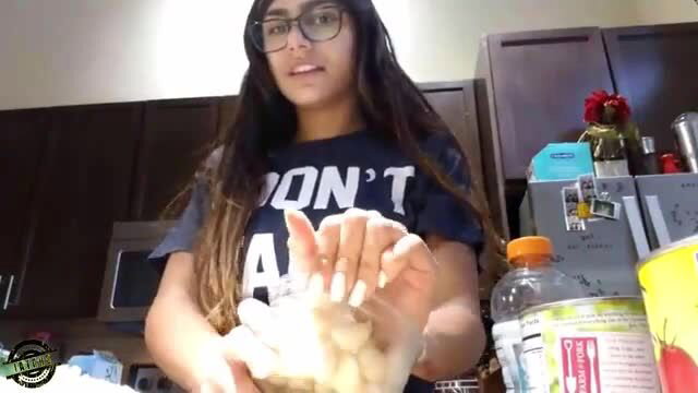 Mia Khalifa kneading dough in kitchen, sexy glasses and tee