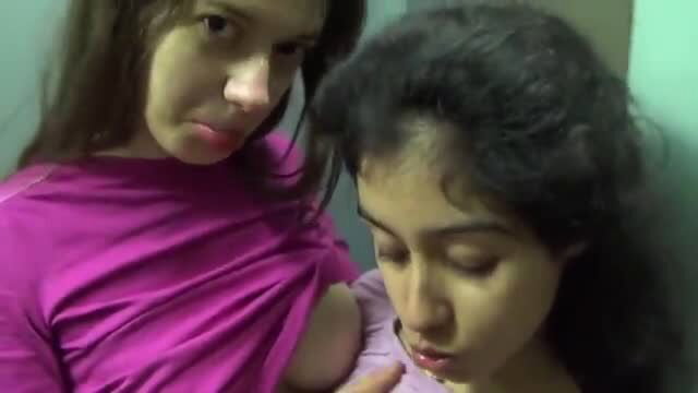 Two busty Asian babes breastfeeding in tight pink tops, lesbian tease