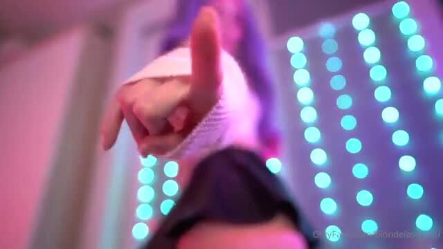 Blondelashes19 closeup pointing finger with white wrist wrap, neon-lit tease