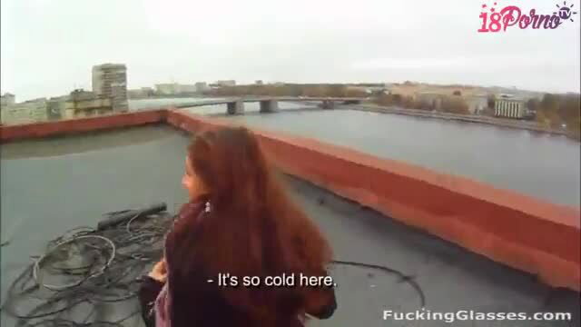 Sexy redhead teen kneels on cold Moscow rooftop for POV blowjob