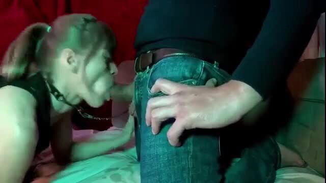 Submissive girl in collar kneels, faces bulge in jeans, facesitting tease