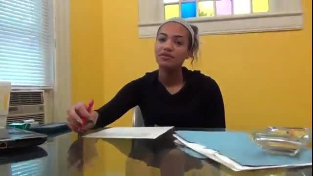 Mixed girl in black top holds pen at desk, sweaty nylon foot worship tease