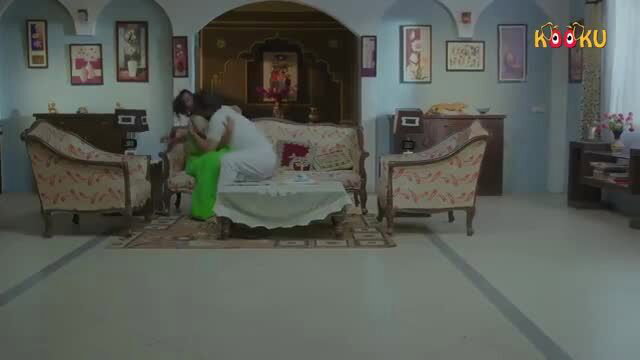 Indian MILF in white saree sits on man's lap in erotic living room scene