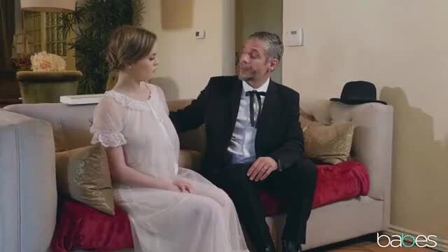 River Fox in sheer lingerie with suited man on couch