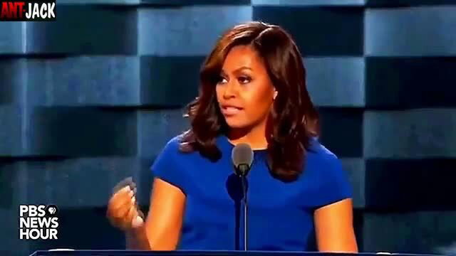 Michelle Obama lookalike in sexy blue dress on stage, deepfake celeb tease
