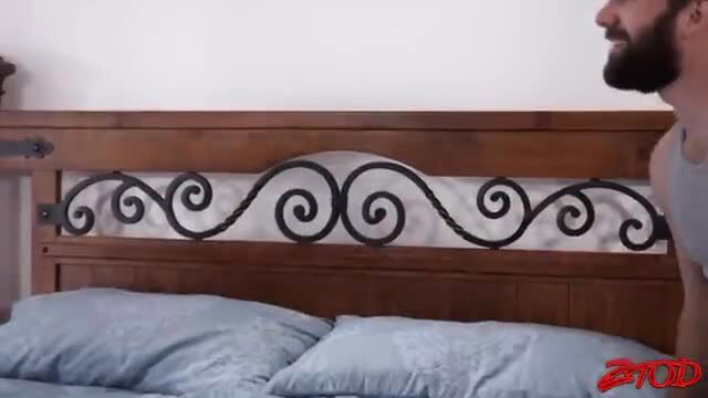 Bearded stud in tank top by ornate bed in Pierce sex scene