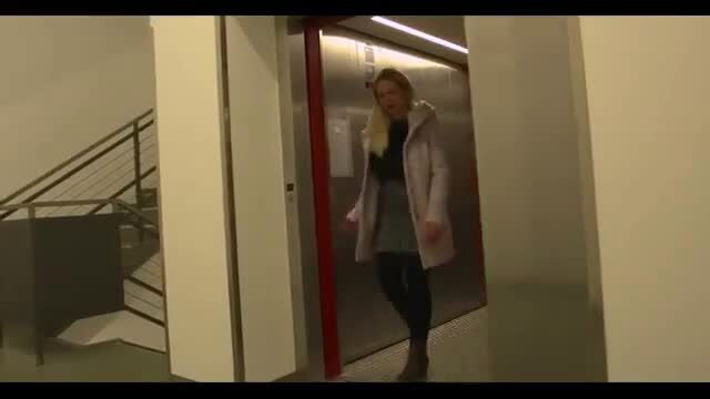 Hot blonde teen in coat and skirt steps out of elevator
