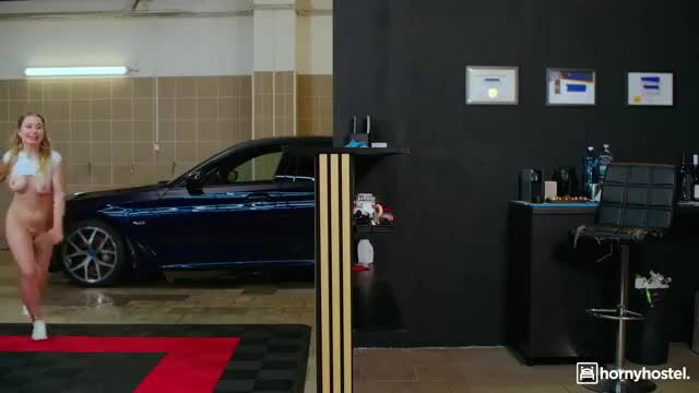 Busty blonde Amalia Davis nude by luxury car in garage