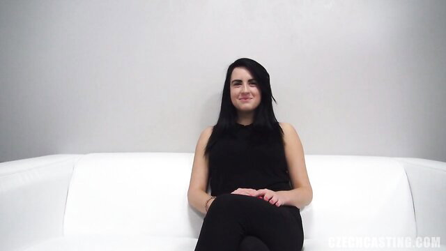 Natalie smiling on couch in black tank top and leggings