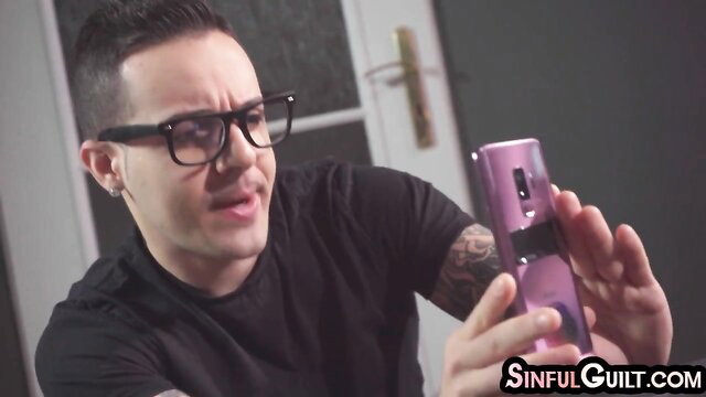 Glasses guy holds pink phone, grimacing in SinfulGuilt anal babe vid