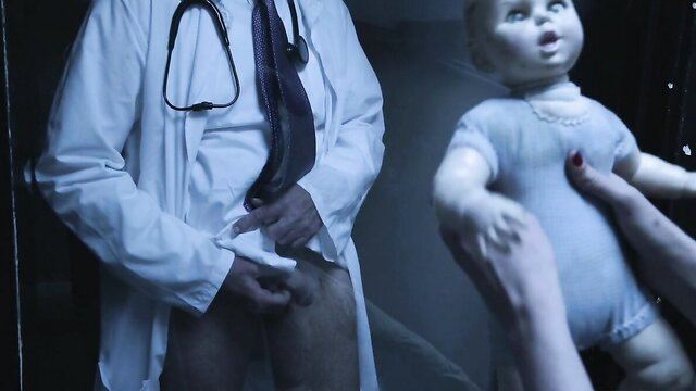 Creepy doctor exposes cock near doll in dark clinic scene