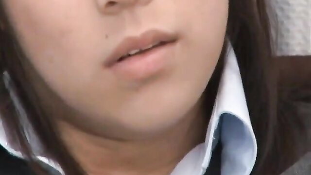 Closeup of young Asian girl's soft pink lips and white collar