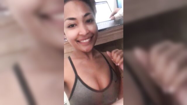 Smiling Brazilian moreninha in tight tank top showing cleavage selfie