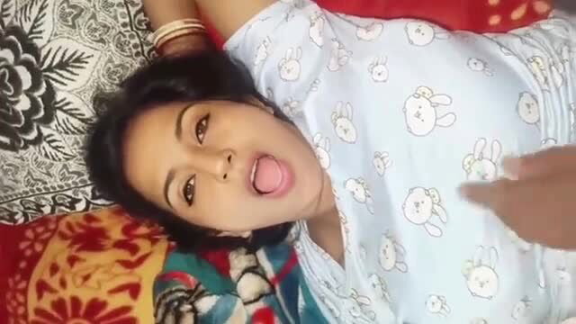 Indian woman sticks out tongue in teasing closeup, vibro play