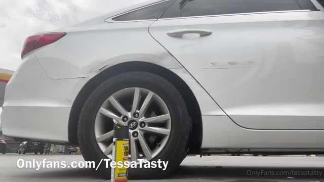 Tessa Tasty bends over white car flat tire in tight dress, hot roadside tease